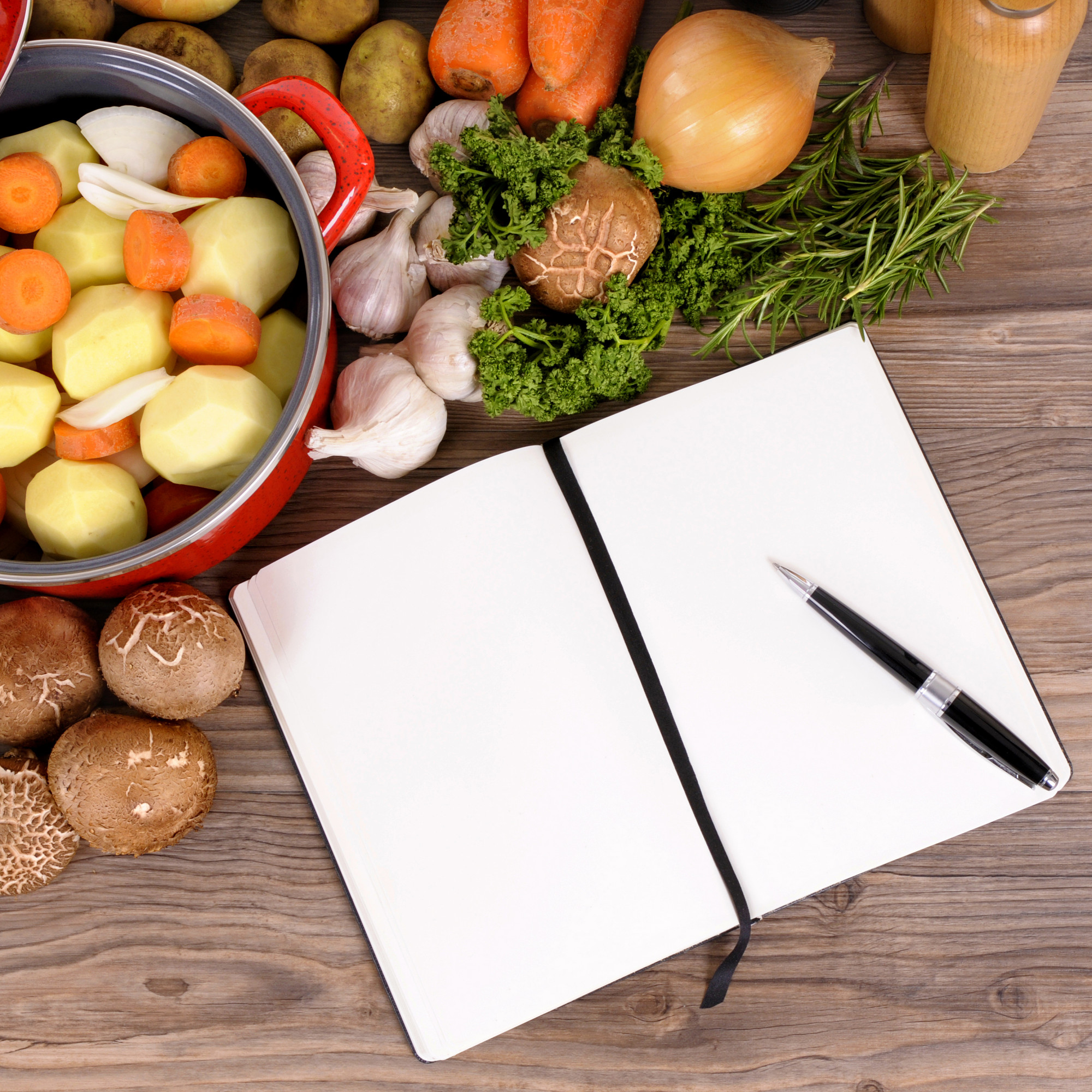Local market produce and chef notebook on wooden table